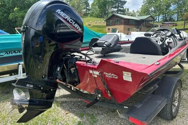 Slide: The Image of 2023 Tracker Pro Team 195 TXW Tournament Edition boat with Mercury engine, parked outdoors. - 2