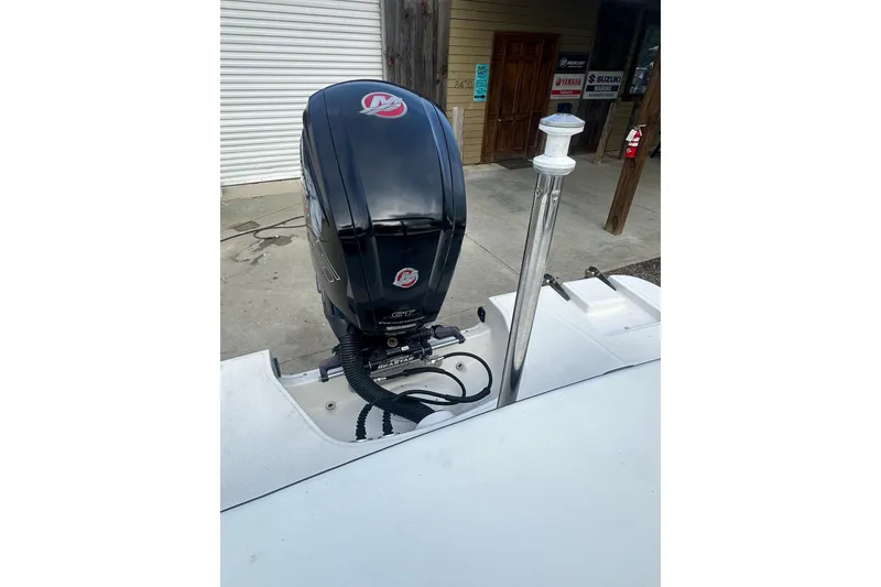 Slide: The Image of 2017 Sea Ray SPX 190 Outboard motor, docked, with visible engine and surroundings. - 13