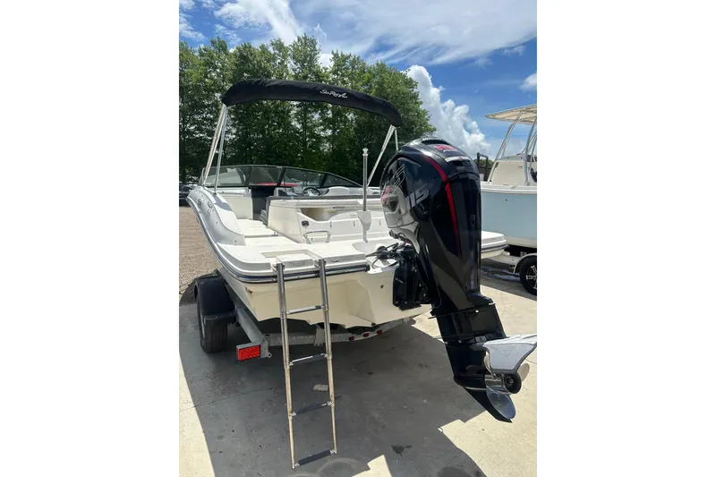 Slide: The Image of 2017 Sea Ray SPX 190 Outboard boat with ladder and outboard motor, parked outdoors. - 14