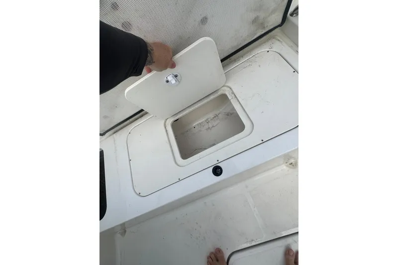 Slide: The Image of 2017 Sea Ray SPX 190 Outboard boat storage compartment being opened. - 19