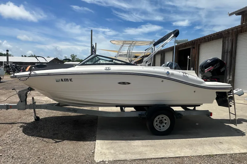 Slide: The Image of 2017 Sea Ray SPX 190 Outboard boat on trailer, parked outdoors under blue sky. - 2