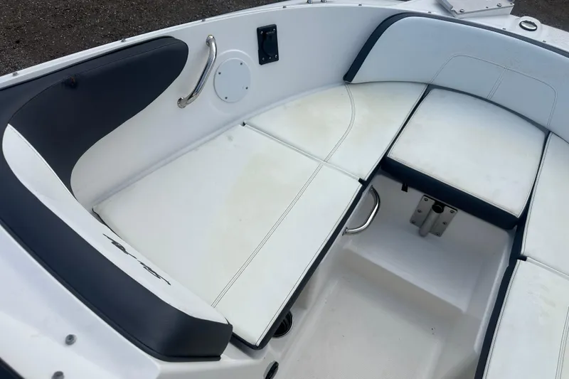 Slide: The Image of 2017 Sea Ray SPX 190 Outboard boat interior with white cushioned seating. - 21