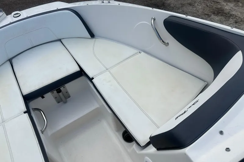 Slide: The Image of 2017 Sea Ray SPX 190 Outboard boat interior with white cushioned seating and stainless steel handles. - 22