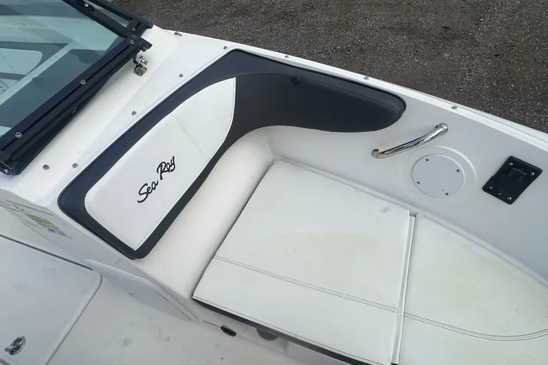 Slide: The Image of 2017 Sea Ray SPX 190 Outboard boat interior with white seating and logo. - 23