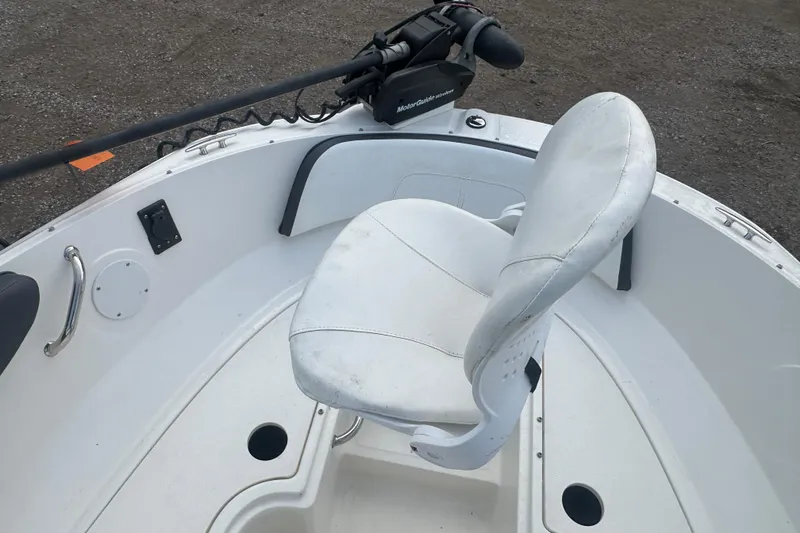Slide: The Image of 2017 Sea Ray SPX 190 Outboard boat interior with white seating and trolling motor. - 24