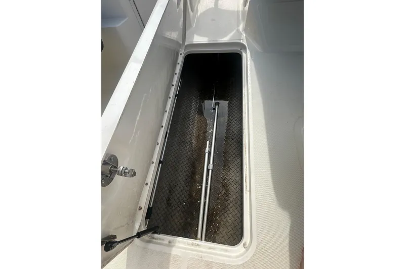 Slide: The Image of Storage compartment of 2017 Sea Ray SPX 190 Outboard boat, featuring diamond-patterned flooring. - 31