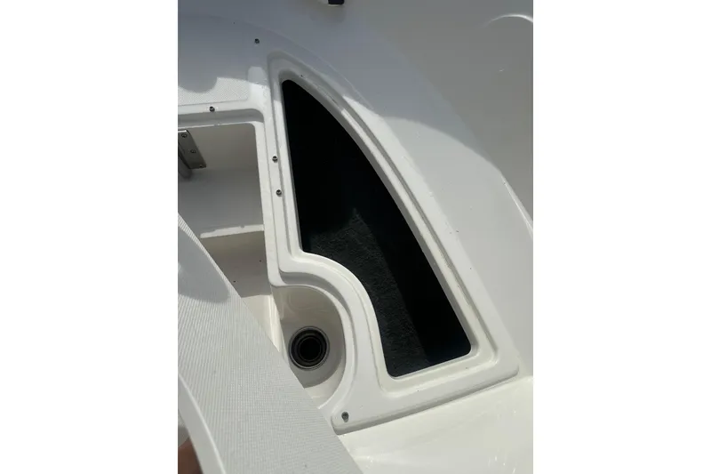 Slide: The Image of Storage compartment on a 2017 Sea Ray SPX 190 Outboard boat, featuring sleek white design. - 35