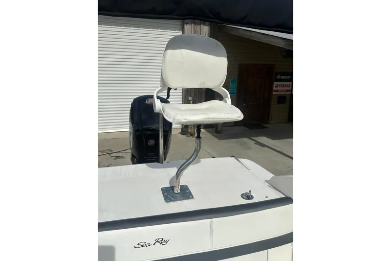 Slide: The Image of 2017 Sea Ray SPX 190 Outboard boat with white captain's chair and visible engine. - 38