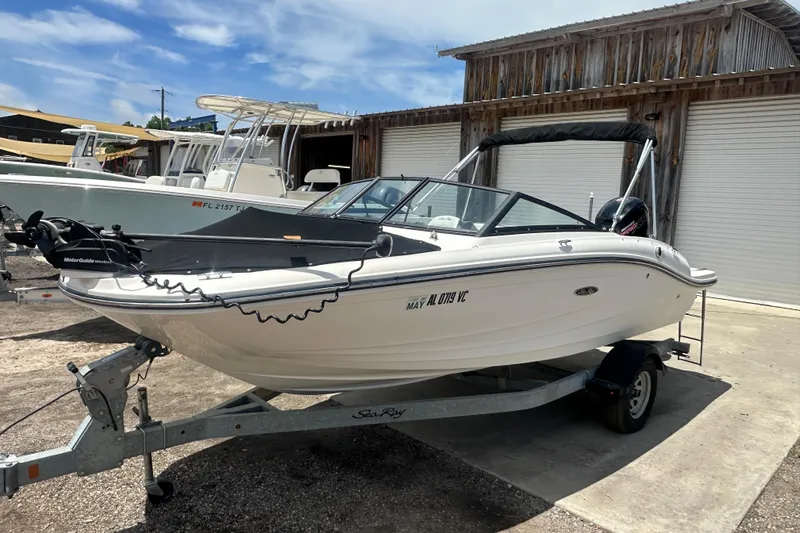Slide: The Image of 2017 Sea Ray SPX 190 Outboard boat on trailer, parked outdoors near wooden building. - 4