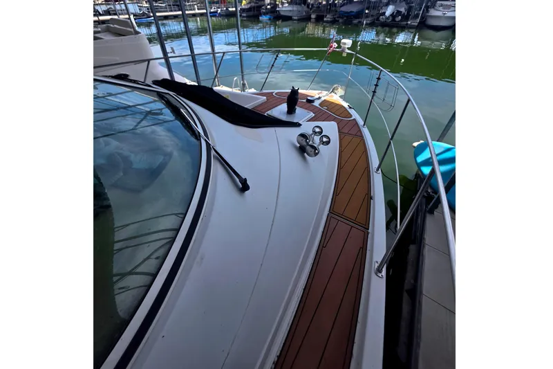 Slide: The Image of 2001 Carver 350 Mariner yacht deck with wooden accents, docked in a marina. - 12