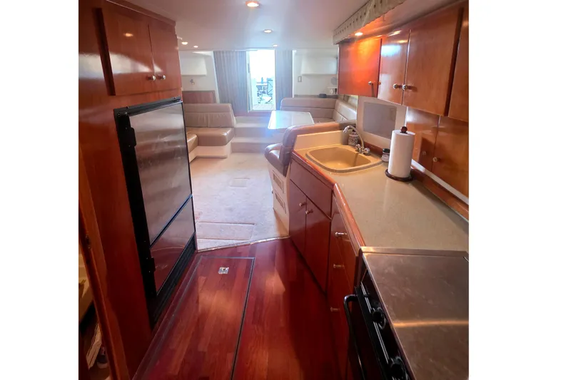Slide: The Image of Interior of 2001 Carver 350 Mariner yacht with kitchen and seating area. - 14