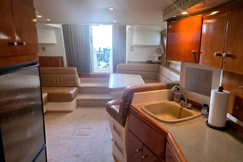 Slide: The Image of Interior of a 2001 Carver 350 Mariner yacht with kitchen and seating area. - 15