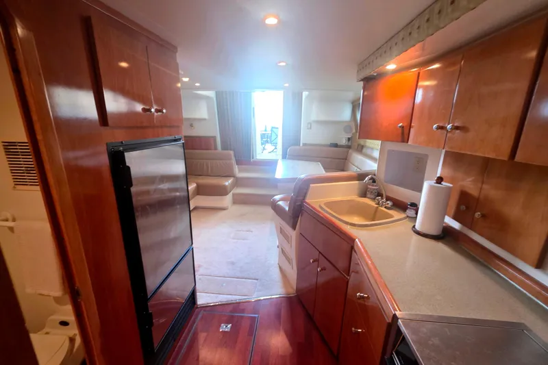 Slide: The Image of Interior of 2001 Carver 350 Mariner yacht with kitchen and seating area. - 16