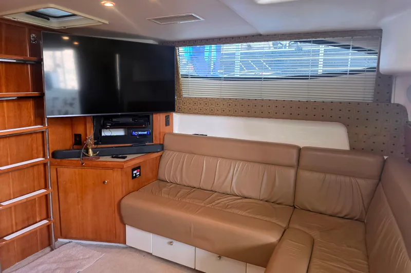 Slide: The Image of Interior of 2001 Carver 350 Mariner yacht with leather seating and entertainment system. - 18