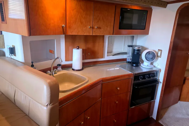 Slide: The Image of Interior of 2001 Carver 350 Mariner yacht kitchen with sink, stove, and microwave. - 19