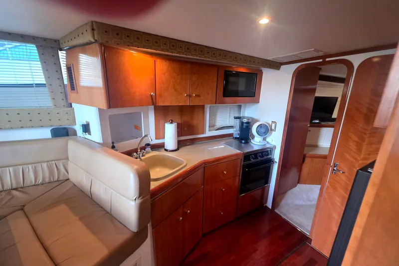 Slide: The Image of Interior of 2001 Carver 350 Mariner yacht featuring kitchen and seating area. - 20