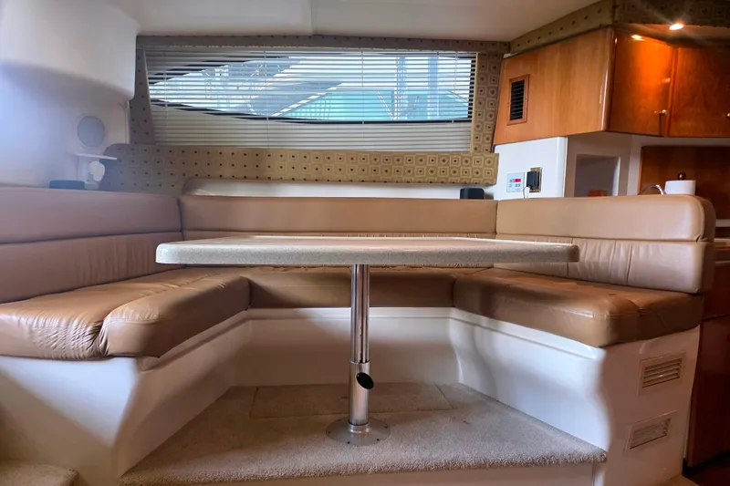Slide: The Image of Interior of 2001 Carver 350 Mariner yacht with beige seating and table. - 21