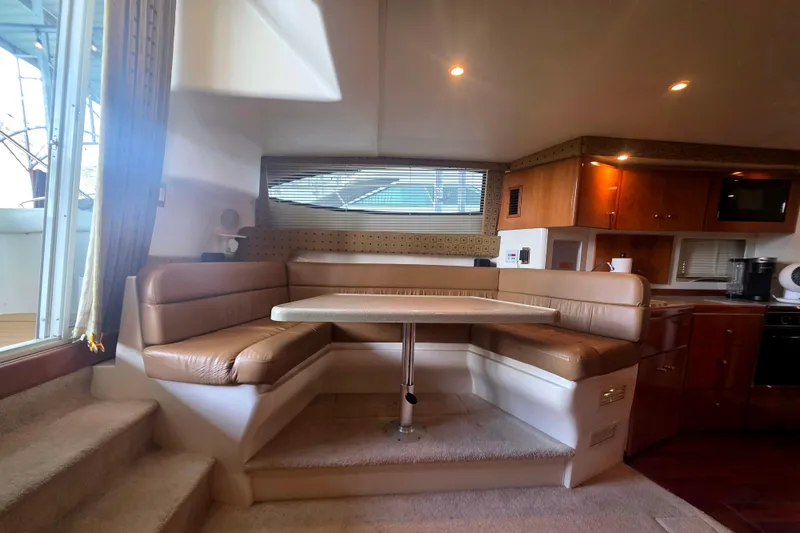 Slide: The Image of Interior of 2001 Carver 350 Mariner yacht with cozy dining area and modern kitchen. - 22