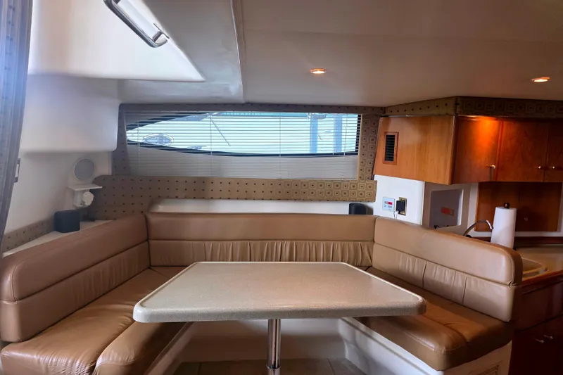 Slide: The Image of Interior of 2001 Carver 350 Mariner yacht with cozy seating and dining area. - 23