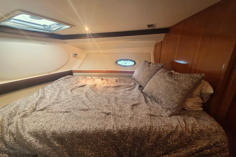 Slide: The Image of Luxurious cabin interior of 2001 Carver 350 Mariner yacht with cozy bedding. - 26