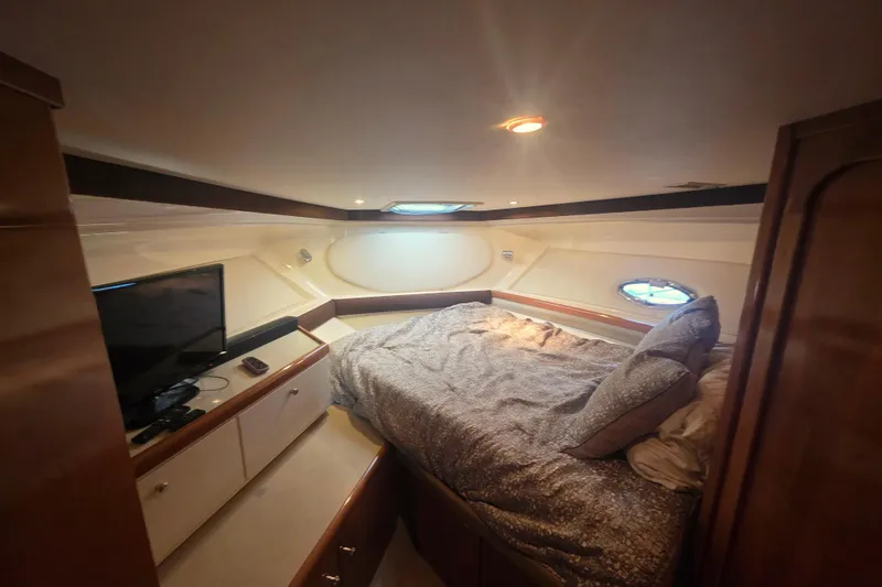 Slide: The Image of Luxurious cabin interior of a 2001 Carver 350 Mariner yacht with cozy bedding and TV. - 28