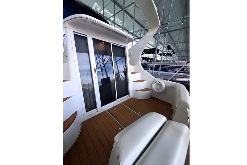 Slide: The Image of 2001 Carver 350 Mariner yacht deck with sliding glass doors and wooden flooring. - 3
