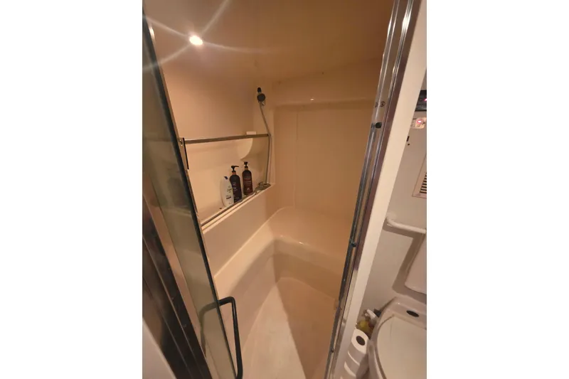 Slide: The Image of Bathroom interior of 2001 Carver 350 Mariner yacht, featuring a shower and toiletries. - 30