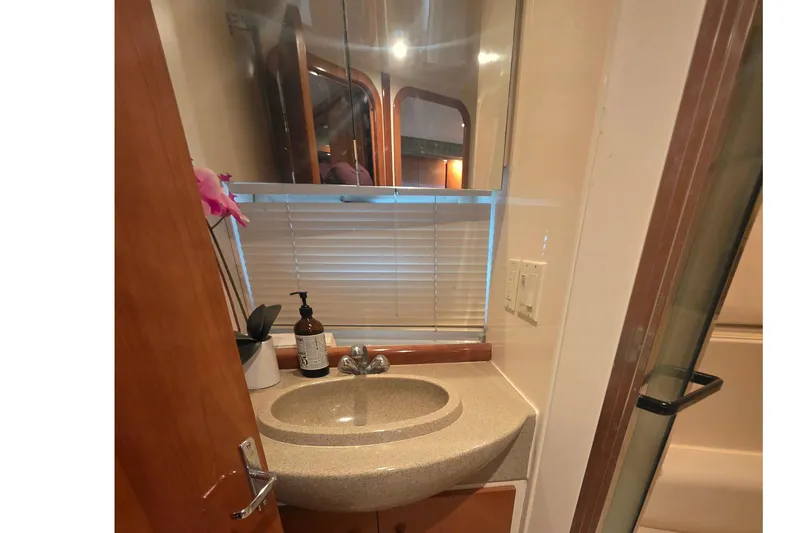 Slide: The Image of 2001 Carver 350 Mariner bathroom with sink, mirror, and decorative elements. - 31