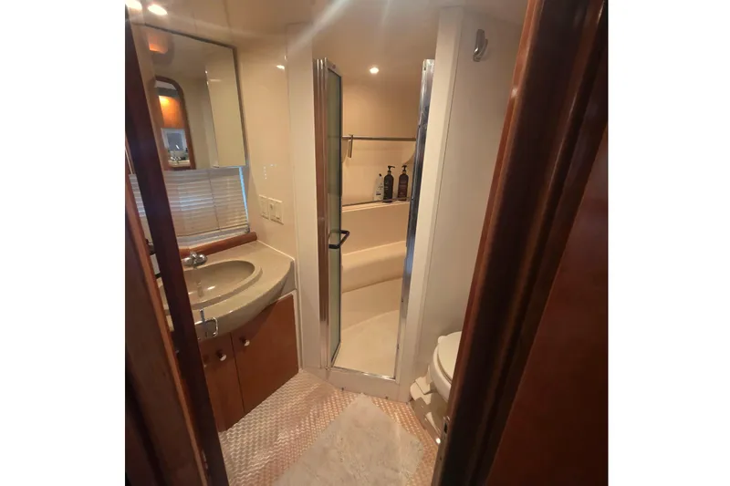 Slide: The Image of Bathroom interior of 2001 Carver 350 Mariner yacht, featuring sink, shower, and toilet. - 32