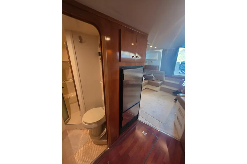 Slide: The Image of Interior of 2001 Carver 350 Mariner yacht with bathroom, fridge, and seating area. - 34