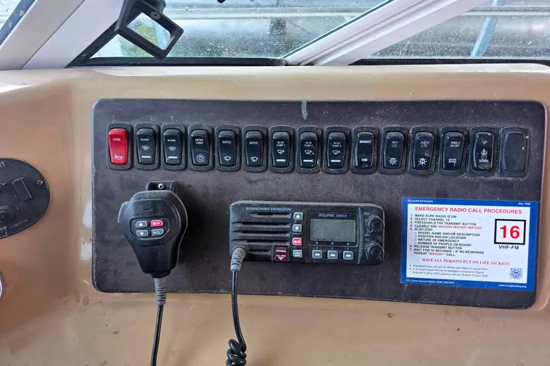 Slide: The Image of Control panel of a 2001 Carver 350 Mariner boat with radio and switches. - 36