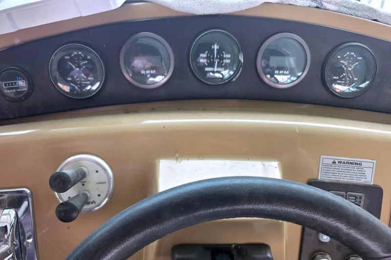Slide: The Image of Dashboard of a 2001 Carver 350 Mariner boat with gauges and controls. - 38