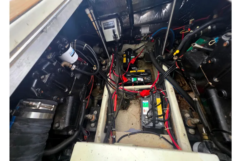 Slide: The Image of Engine compartment of a 2001 Carver 350 Mariner with visible wiring and components. - 42