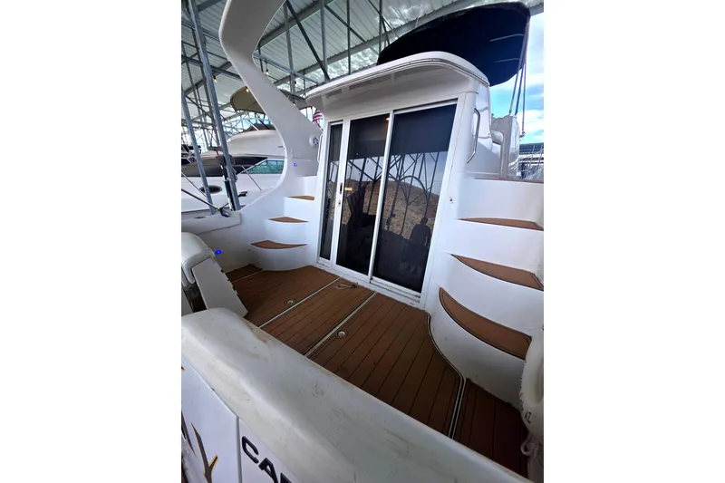 Slide: The Image of 2001 Carver 350 Mariner yacht with teak deck and sliding glass doors in marina. - 5