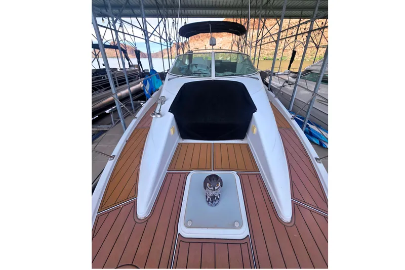 Slide: The Image of 2001 Carver 350 Mariner boat with teak deck, docked under a metal canopy. - 6
