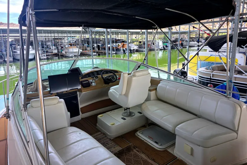 Slide: The Image of 2001 Carver 350 Mariner interior with white seating, docked in a marina. - 8