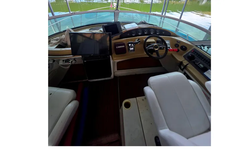 Slide: The Image of Cockpit of 2001 Carver 350 Mariner yacht with steering wheel and navigation equipment. - 9