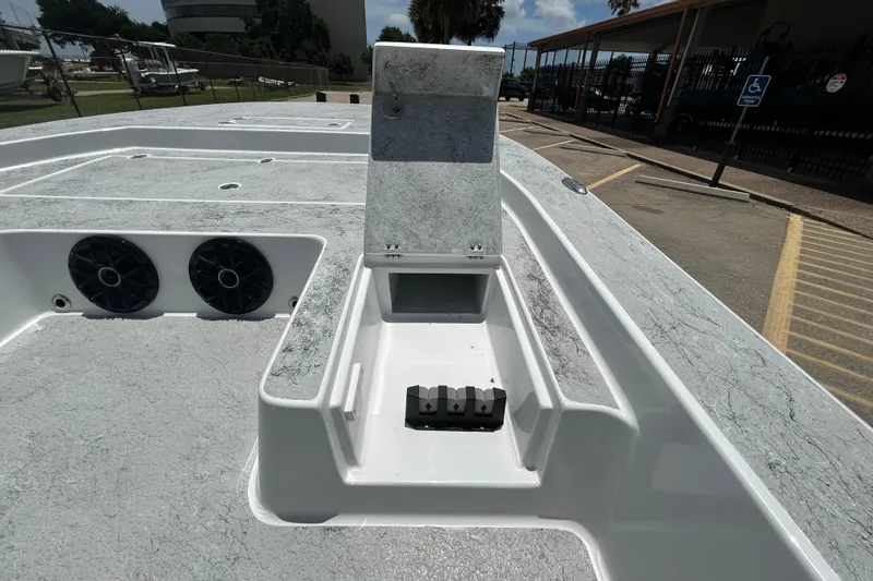 Slide: The Image of 2026 Gulf Coast Saber Cat 25 boat deck with storage compartment and speakers. - 10