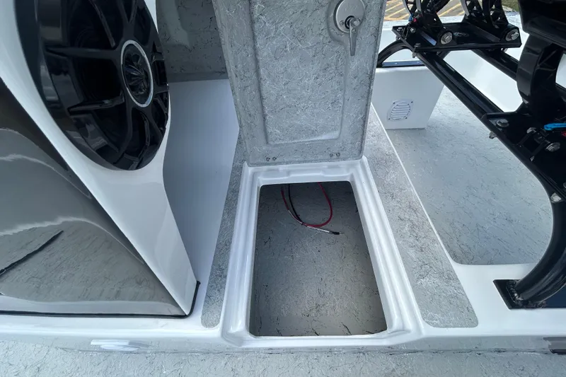 Slide: The Image of 2026 Gulf Coast Saber Cat 25 boat interior with speaker and storage compartment. - 13