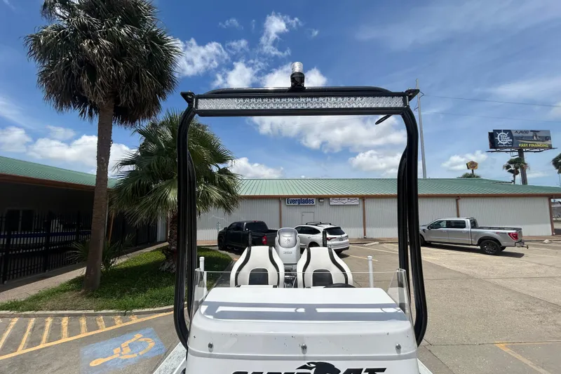 Slide: The Image of 2026 Gulf Coast Saber Cat 25 boat parked, showcasing sleek design under a clear blue sky. - 15