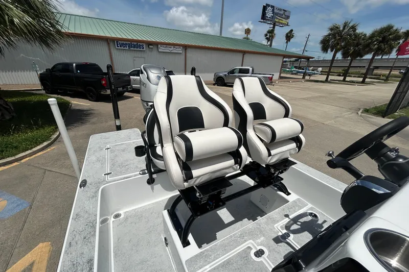 Slide: The Image of 2026 Gulf Coast Saber Cat 25 boat with dual white and black captain seats. - 16