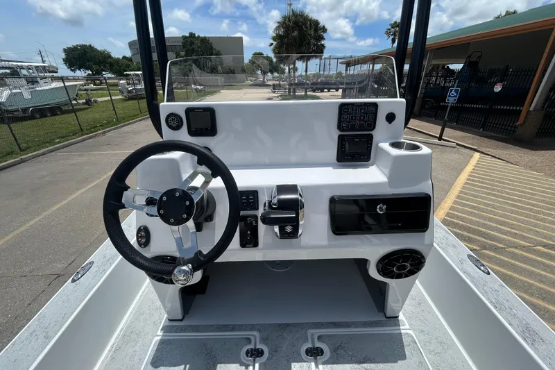 Slide: The Image of 2026 Gulf Coast Saber Cat 25 boat dashboard with steering wheel and controls. - 20
