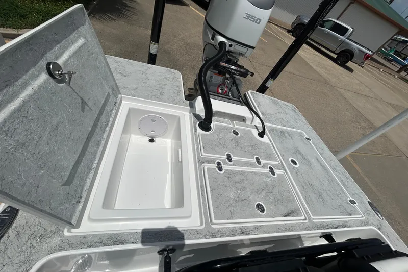 Slide: The Image of 2026 Gulf Coast Saber Cat 25 boat deck with storage compartments and motor. - 24
