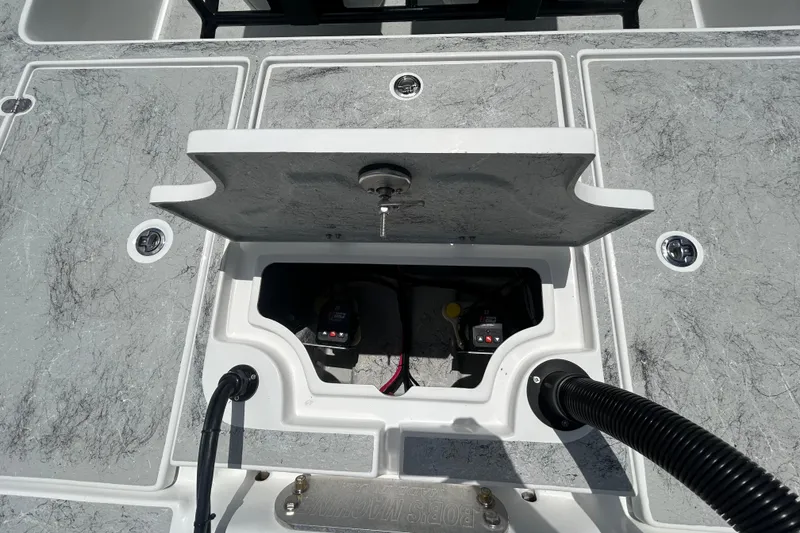 Slide: The Image of Open hatch on 2026 Gulf Coast Saber Cat 25 boat deck, revealing internal components. - 25