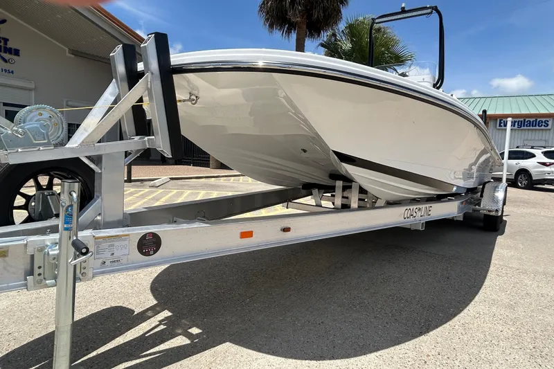 Slide: The Image of 2026 Gulf Coast Saber Cat 25 boat on trailer, parked outdoors. - 3