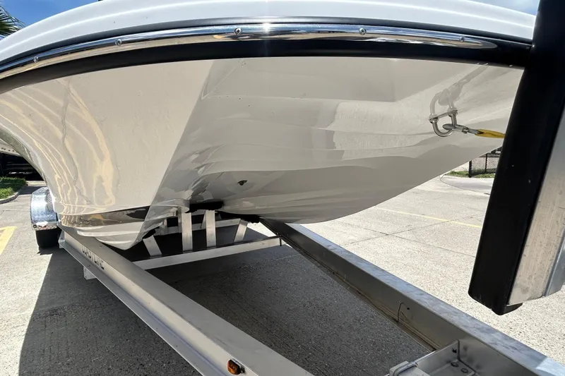 Slide: The Image of 2026 Gulf Coast Saber Cat 25 boat on trailer, showcasing sleek hull design. - 4