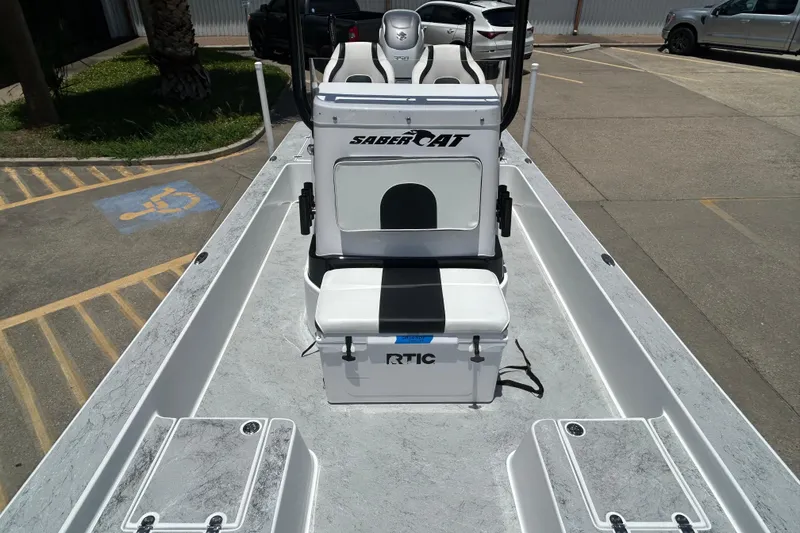 Slide: The Image of 2026 Gulf Coast Saber Cat 25 boat interior with seating and storage compartments. - 6