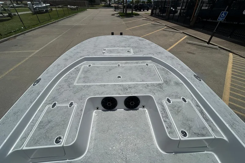 Slide: The Image of 2026 Gulf Coast Saber Cat 25 boat deck, featuring storage compartments and speakers. - 7