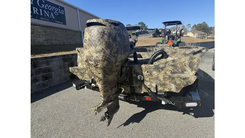 Slide: The Image of 2026 Excel Boats Tomahawk 183 with camouflage pattern on trailer. - 1