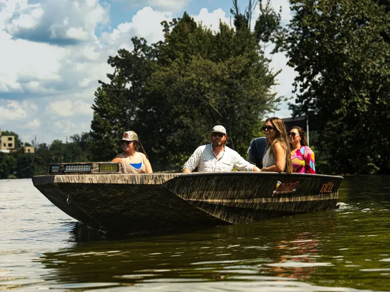 Slide: The Image of 2026 Excel Boats Tomahawk 183 on a river with four people. - 12